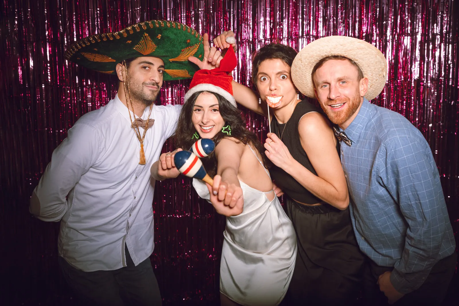 Guests laughing together at a modern GLOWSHOT photo booth during an event