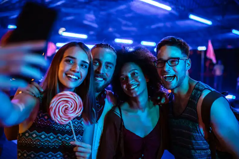 Guest posing on a glowing 360 photo booth platform at a Miami waterfront party
